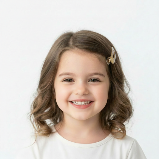 Set of two Golden Glow hair clips from ItFits.ae, featuring shiny gold-tone metal with elegant clasp closures.