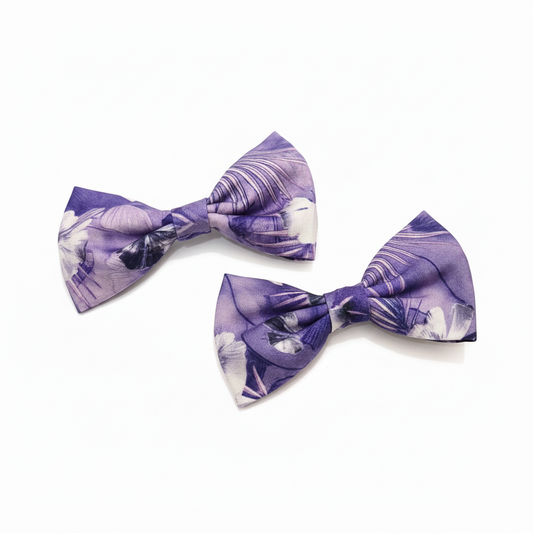 Purple floral hair bows by ItFits.ae featuring delicate flower designs and tied ribbons for stylish hair accessories.
